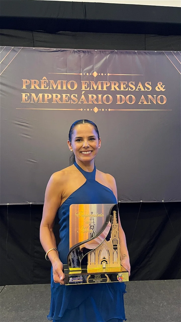 Sônia Mara Cenedese Bastian com o troféu do Prêmio Empresas & Empresário do Ano, ao lado de dois colegas, em 2025
